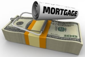 mouse trap with mortgage attached, sitting on stack of 100 dollar bills