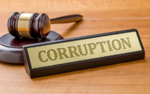 A gavel and a corruption name plate