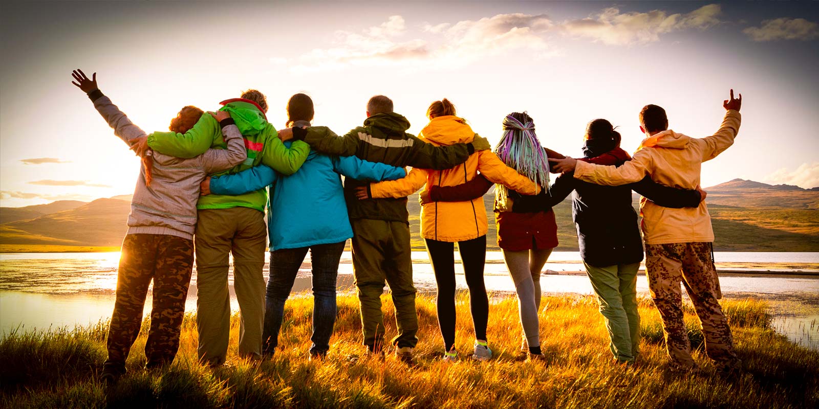 friends standing in front of sunset